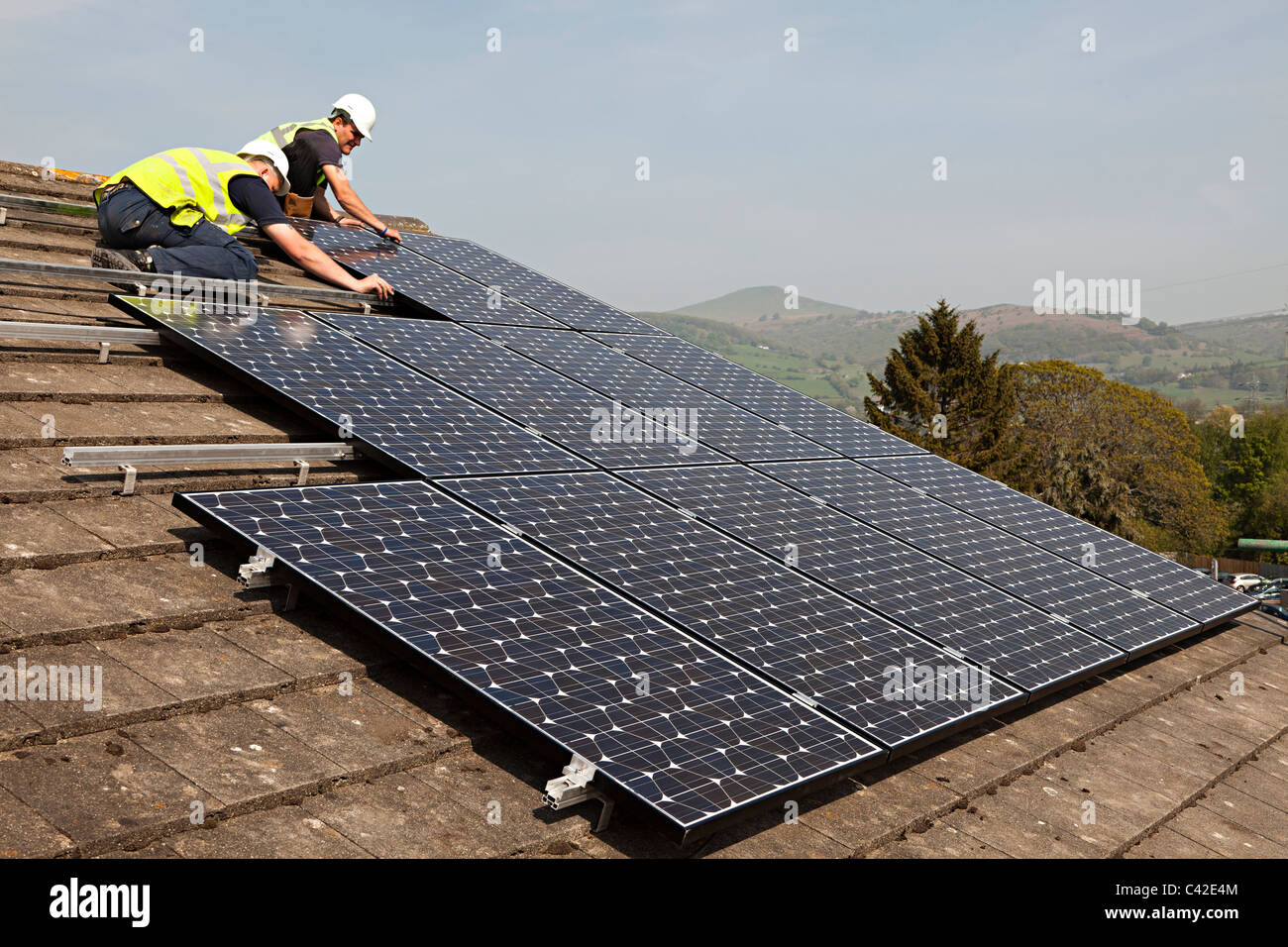 Fitting solar pv panels to house roof Wales UK Stock Photo