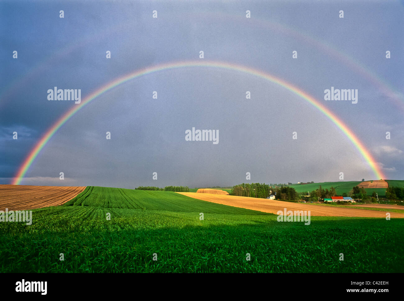 Double rainbow over field near Biei, Hokkaido Prefecture, Japan Stock Photo