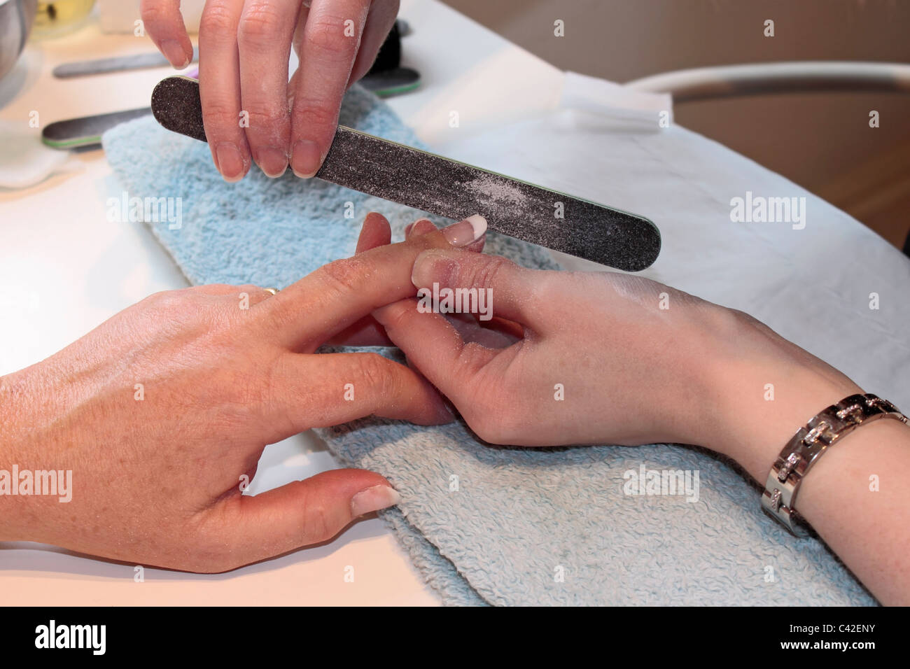 Lady receiving a manicure at a beauty salon. Stock Photo