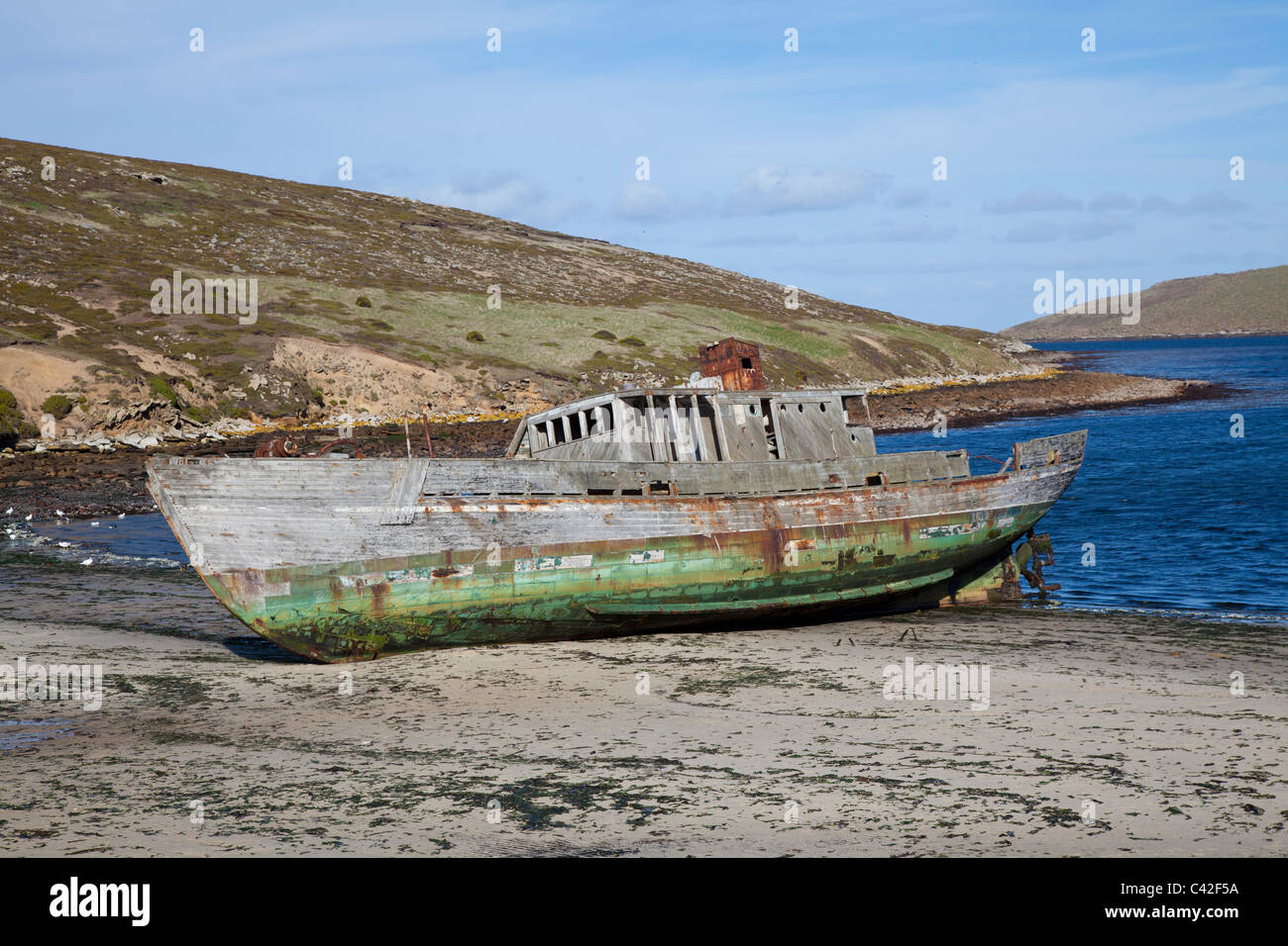 Old wooden boat beached at New Island, West Falklands Stock Photo