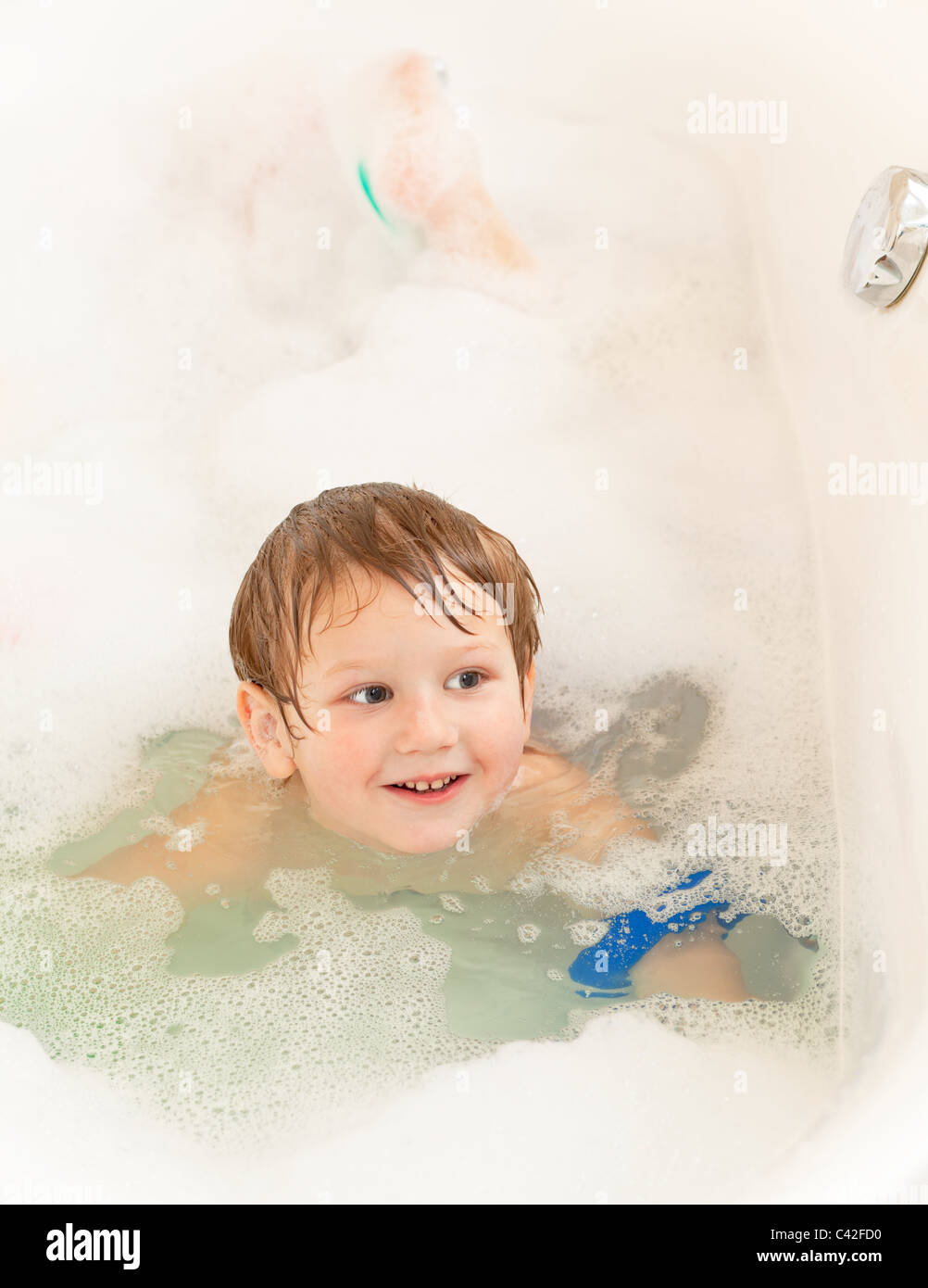 Happy little boy taking bath at home Stock Photo
