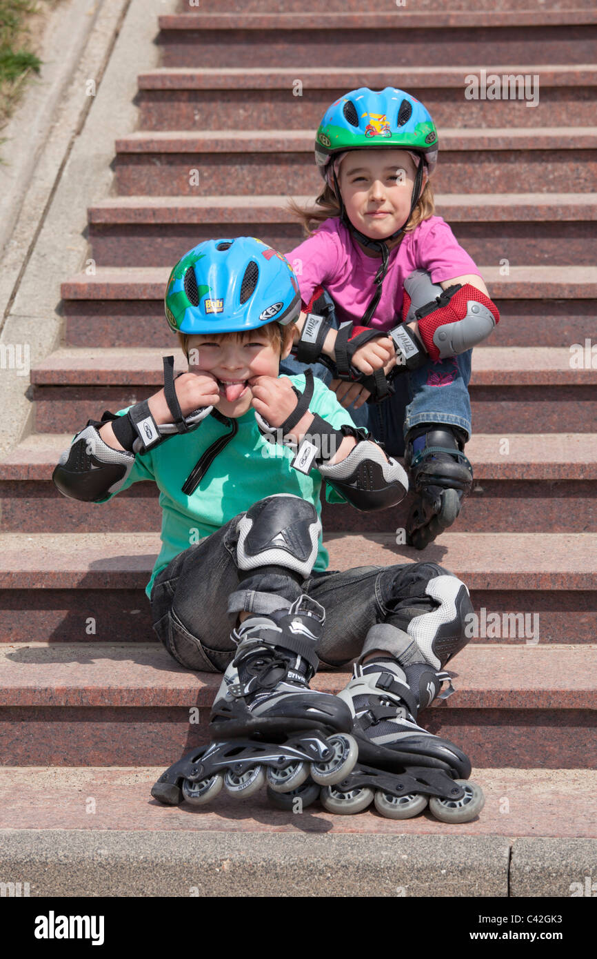 young brother and sister having a break from in-line skating Stock Photo