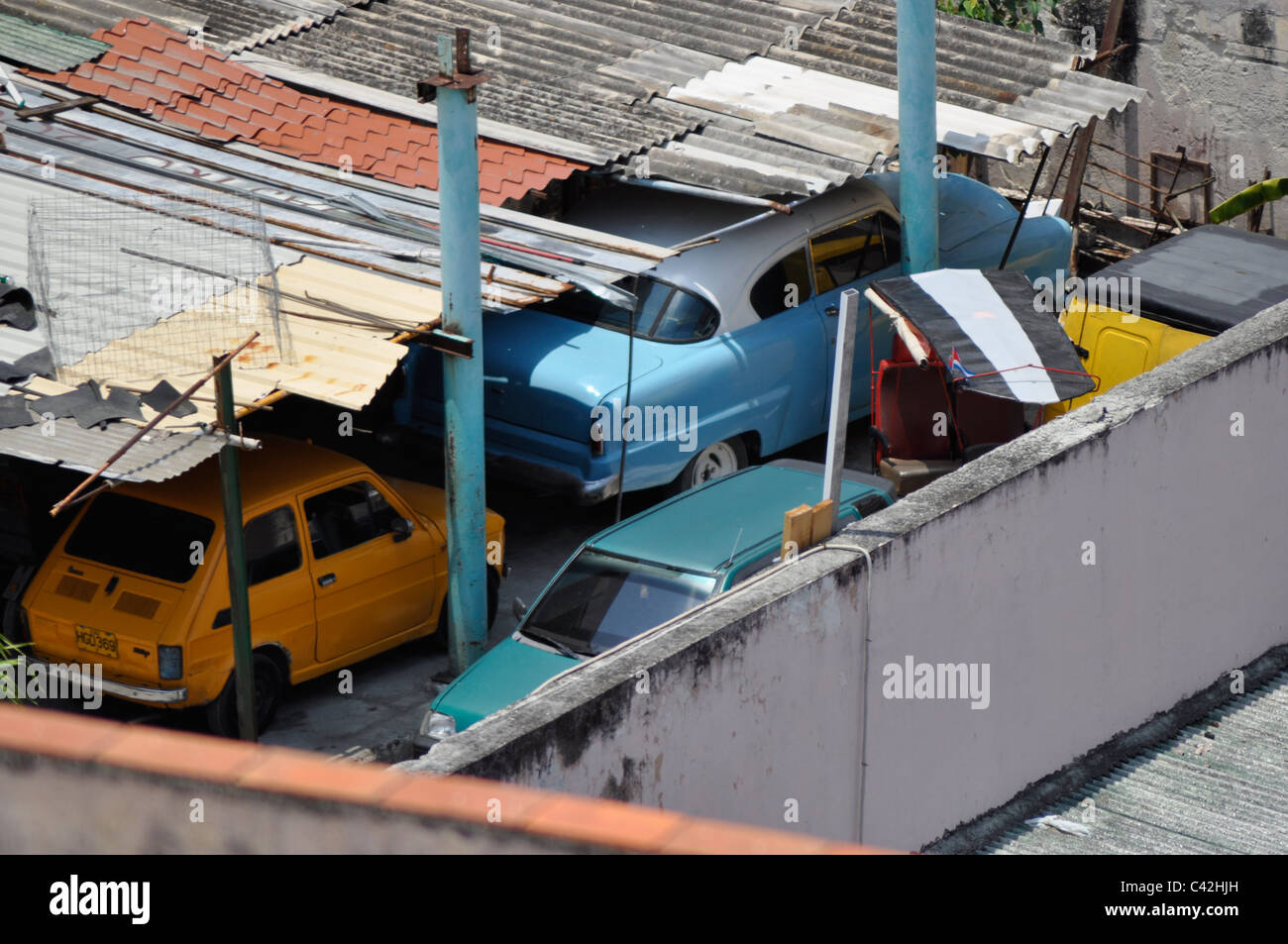 Cuban car garage, in Havana. Hand-built with  mis-matched corrugated iron roofing and walls Stock Photo