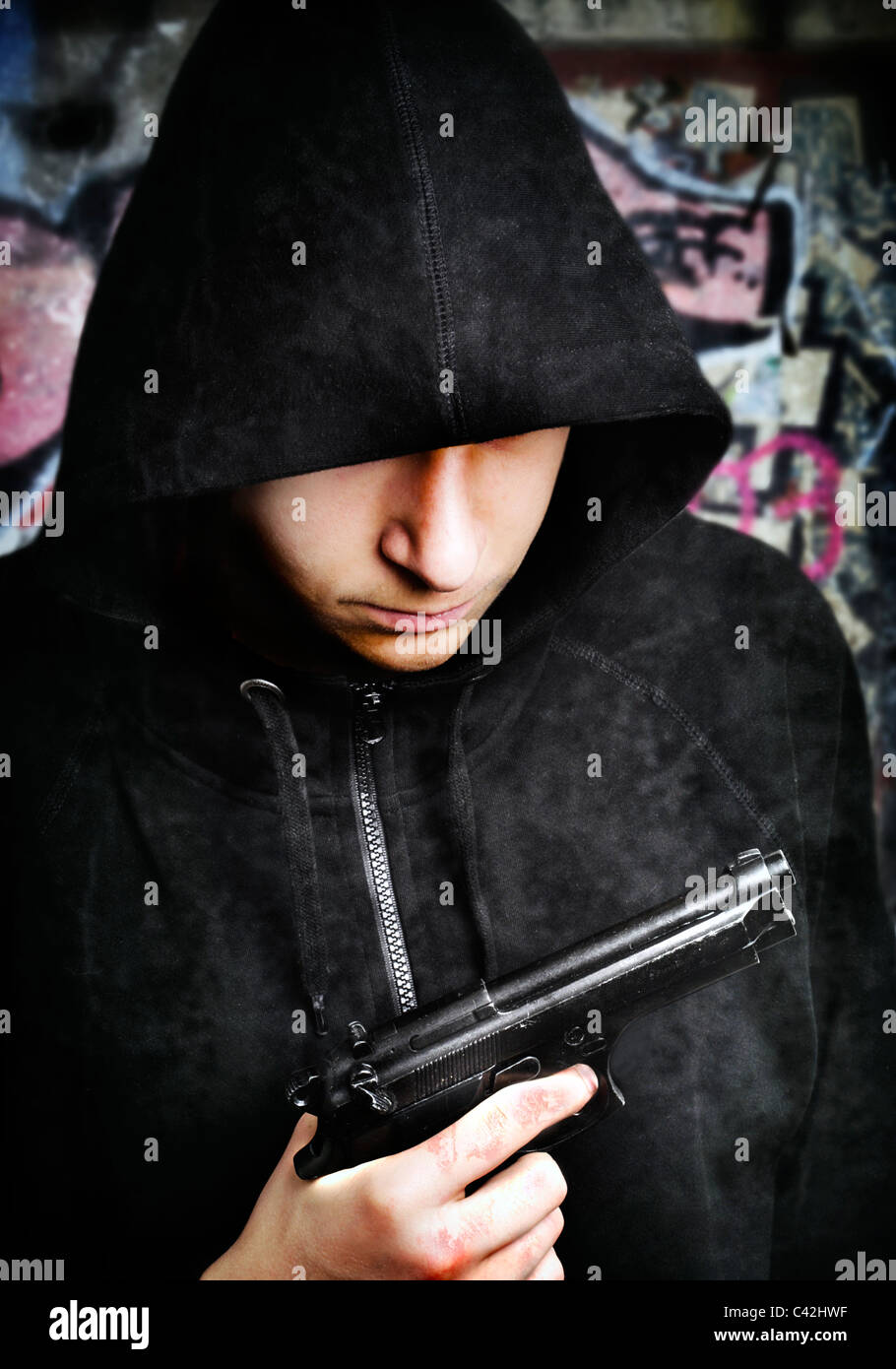 One young man with hand gun Stock Photo