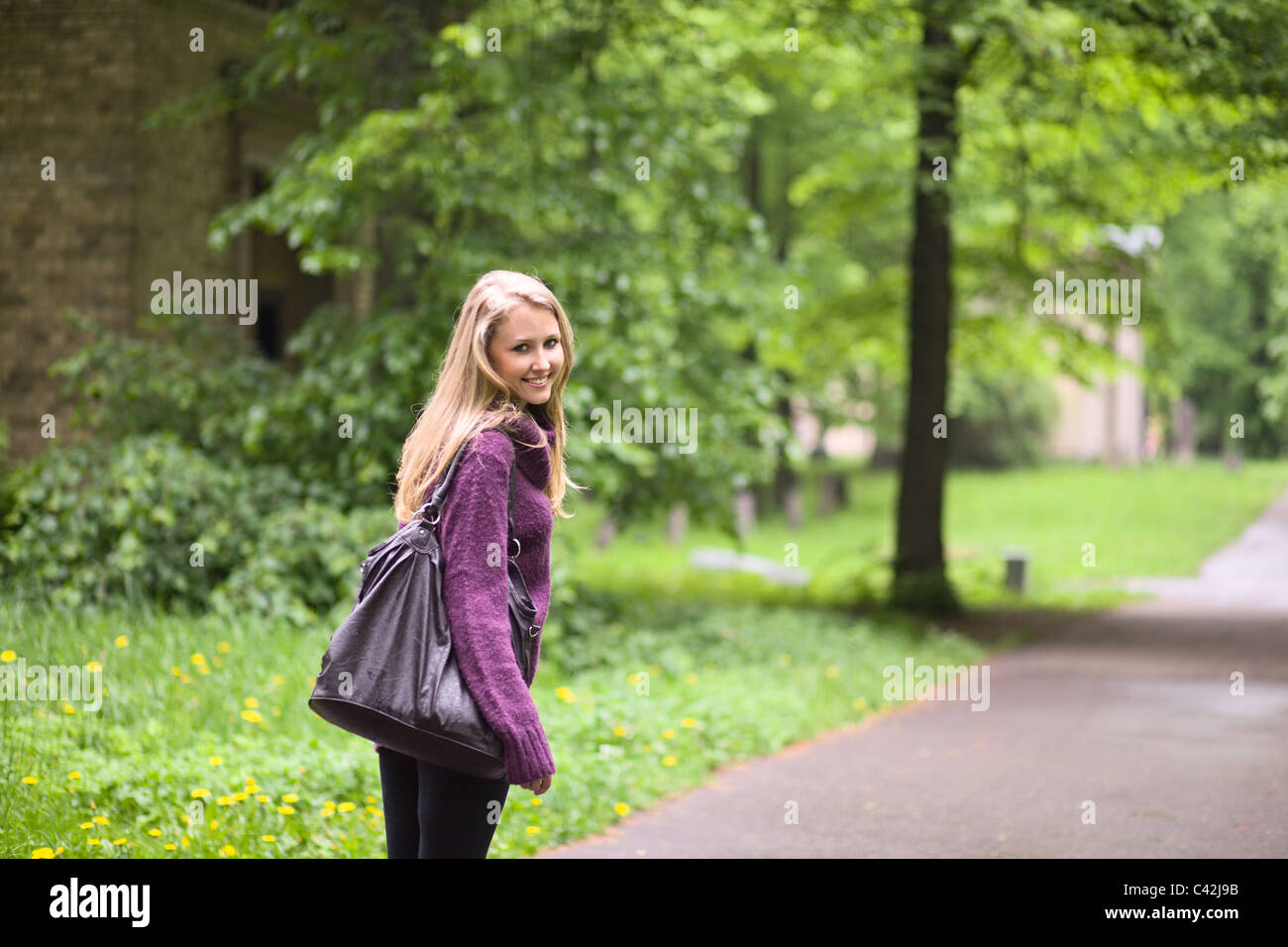 The young smiling woman in park Stock Photo - Alamy