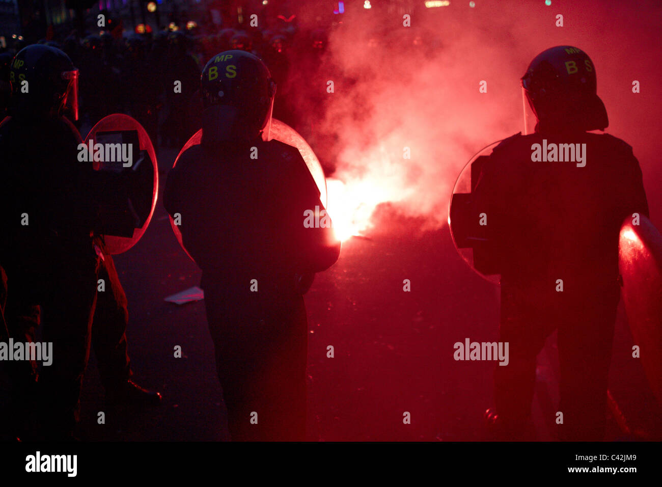 Riot policeman silhouetted against a red flare during the March for the Alternative Stock Photo