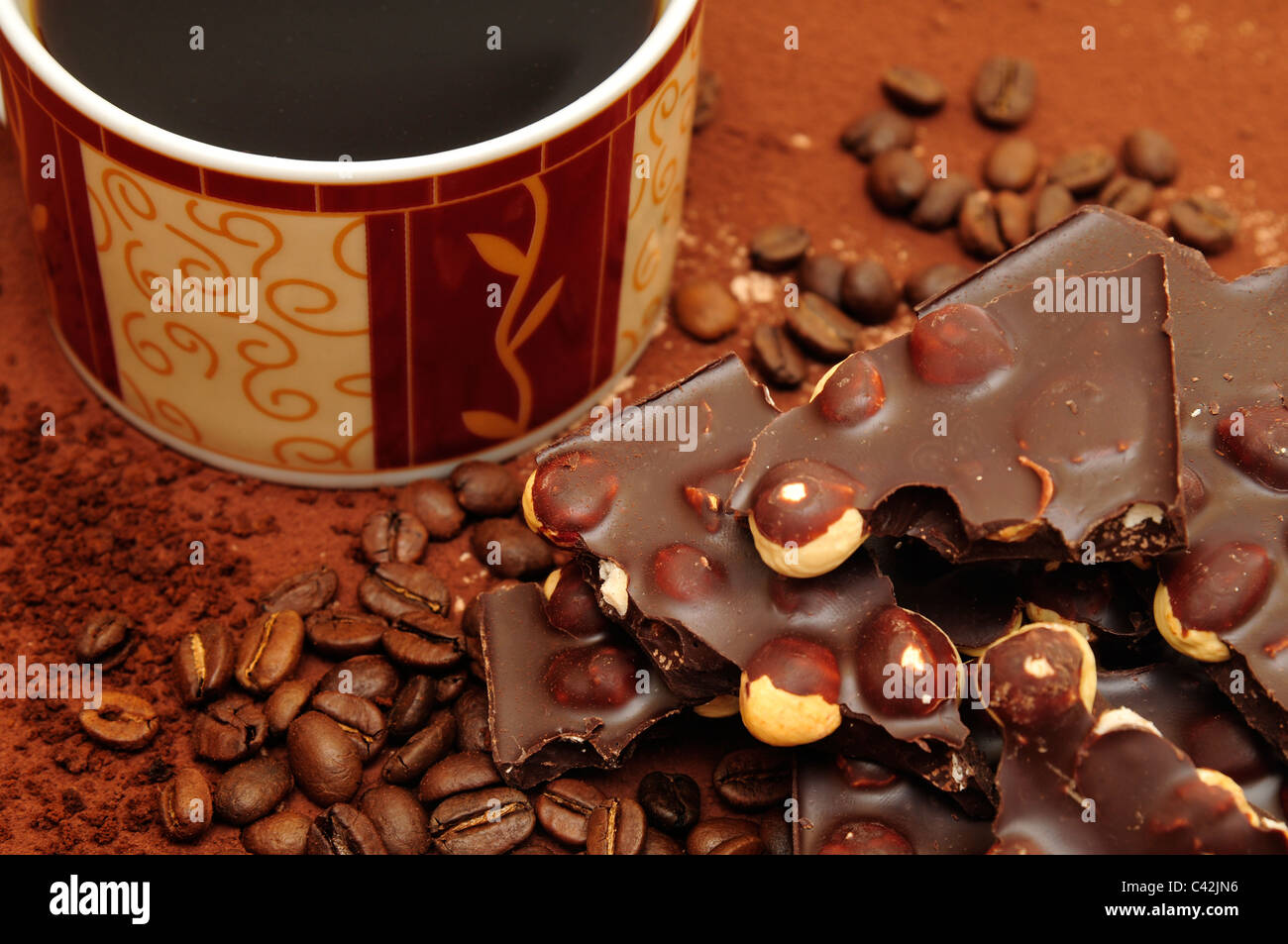 Chocolate with nuts on the brown background. Coffee drink Stock Photo