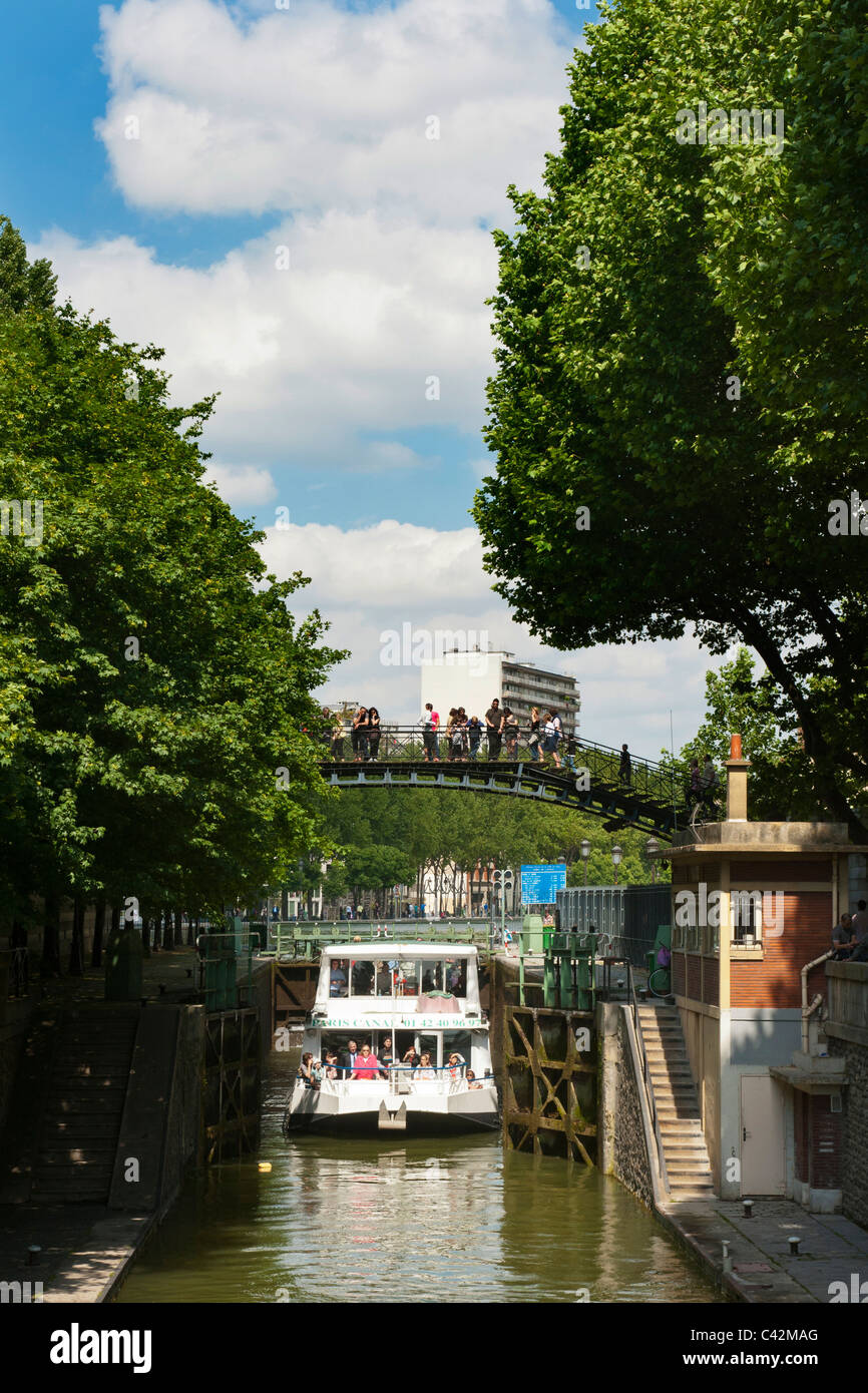 Canauxrama Boat in lock on canal St-Martin, Paris.  L Stock Photo