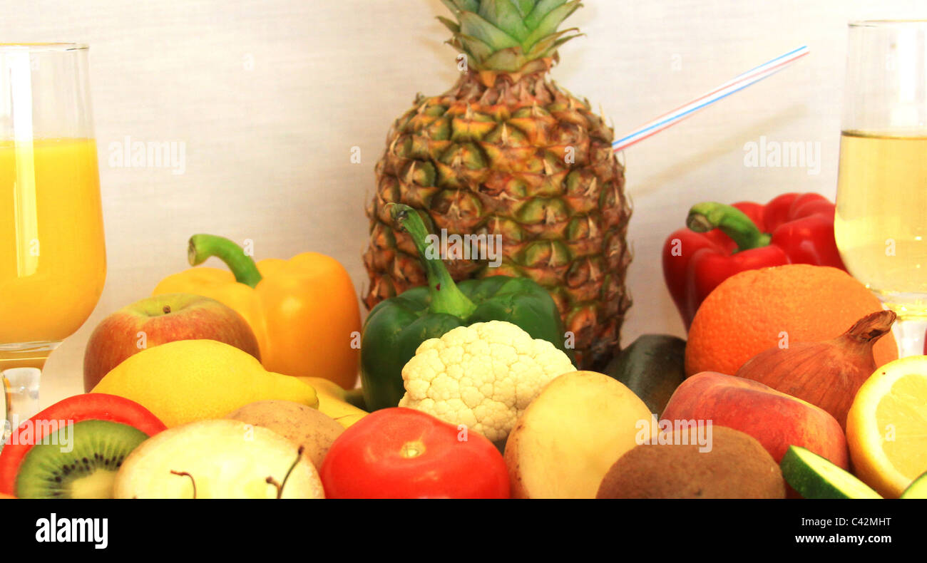 Mixed fruit and vegetables along with wine and orange juice Stock Photo