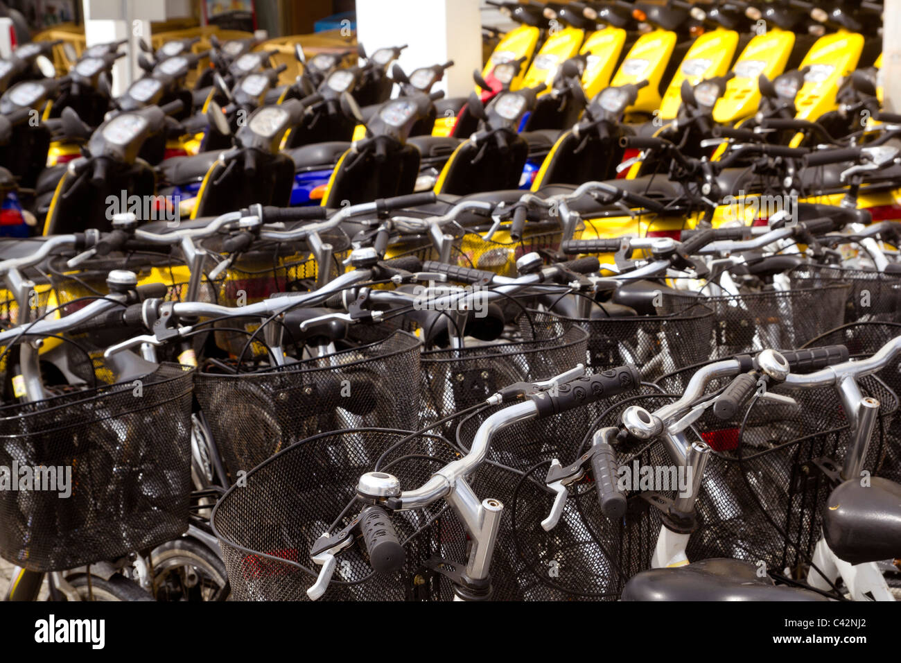 bicycles and scooter bikes rows in a renting shop pattern Stock Photo