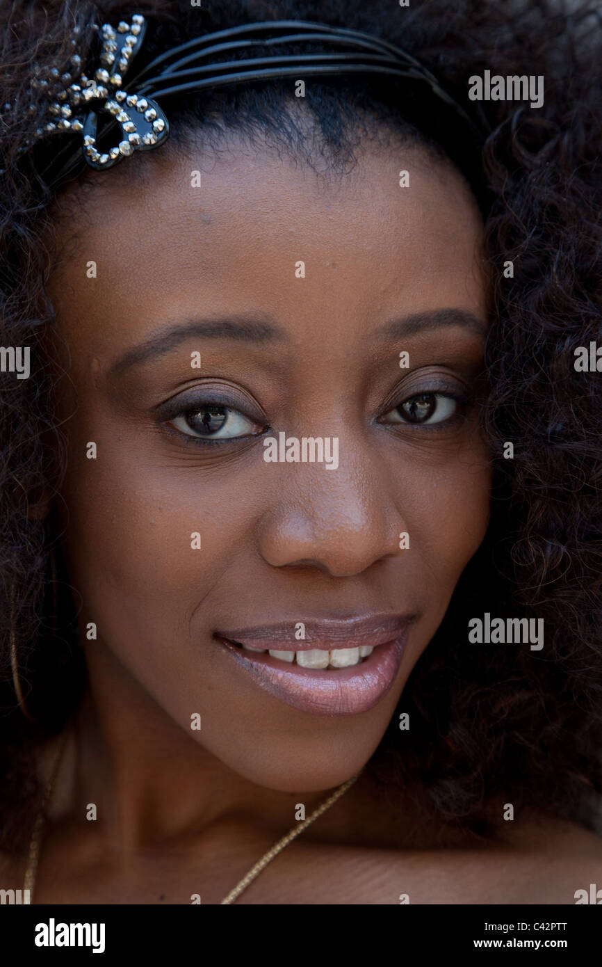 Pretty black woman with a friendly, sweet smile at the camera Stock ...