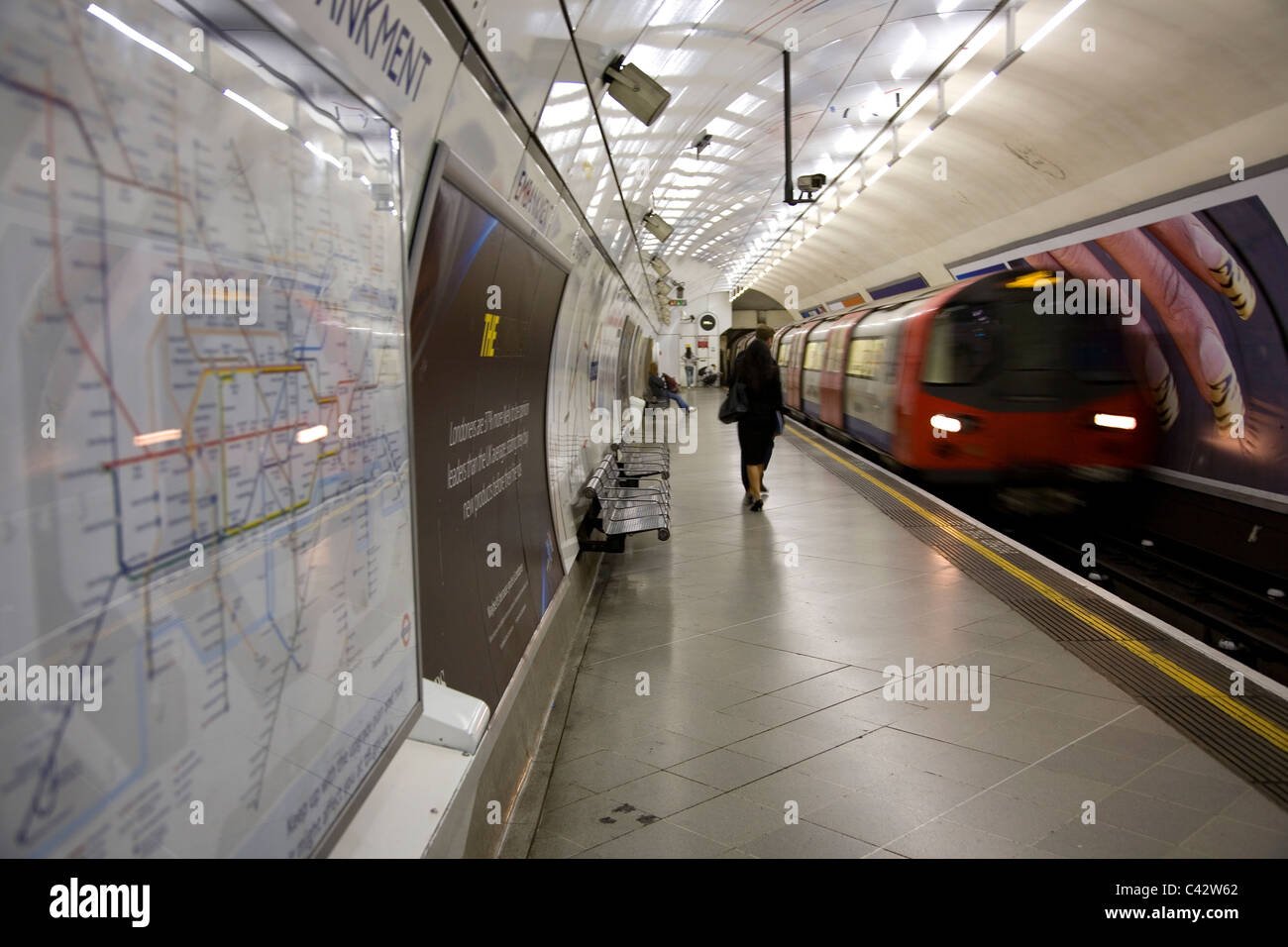 Embankment Station Platform with approaching tube Stock Photo