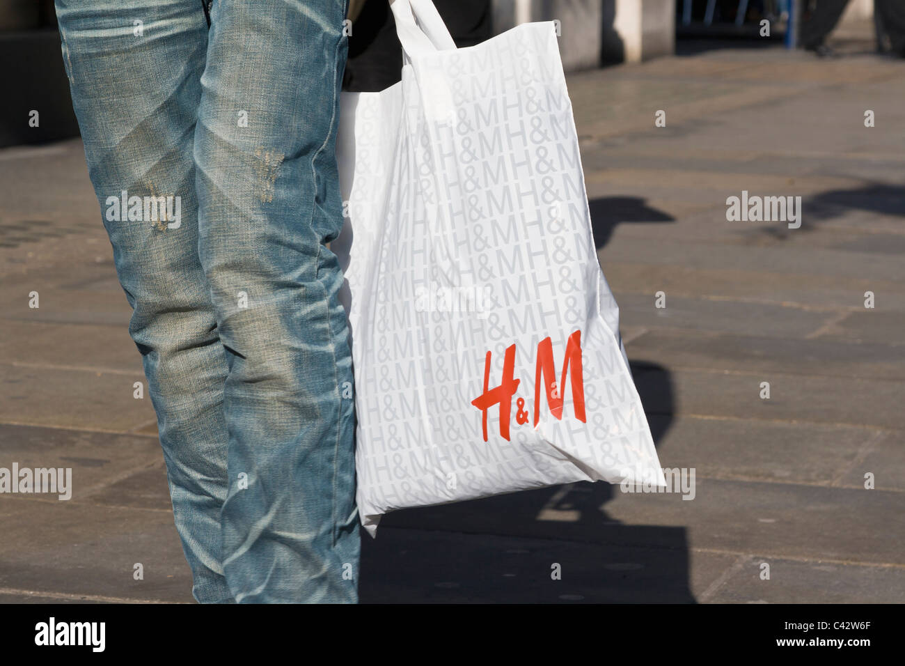 Person carrying H&M shopping bag Stock Photo - Alamy