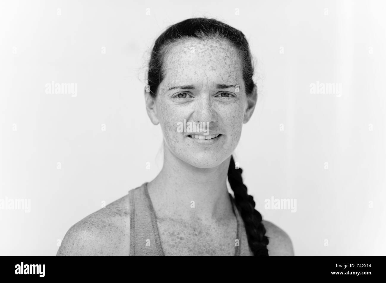 Portrait of woman with pony tail in studio black and white on white Stock Photo