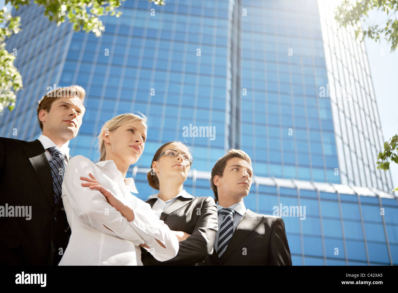Portrait of friendly business group standing in line Stock Photo - Alamy