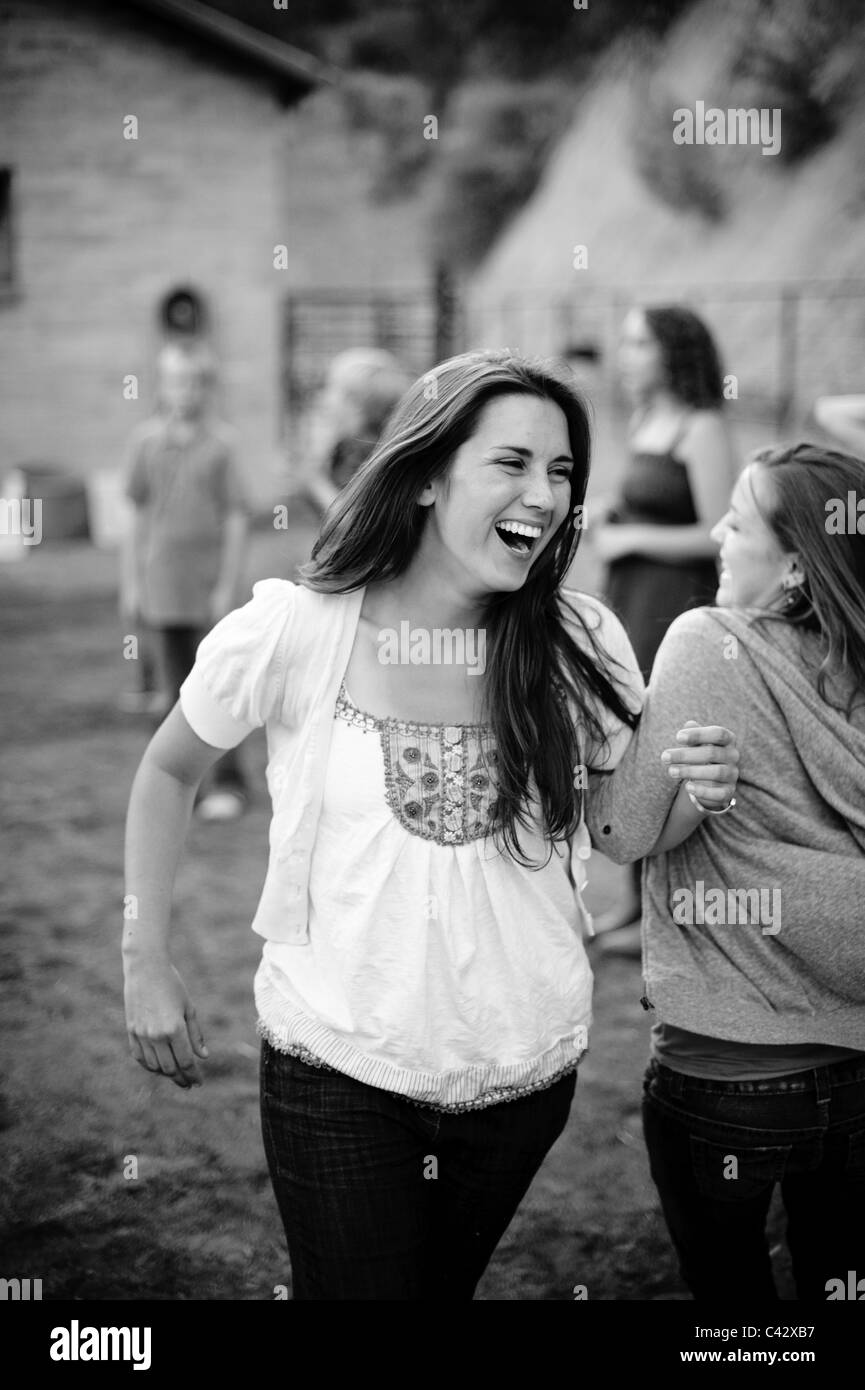 Young woman smiling at barn dance in black and white Stock Photo