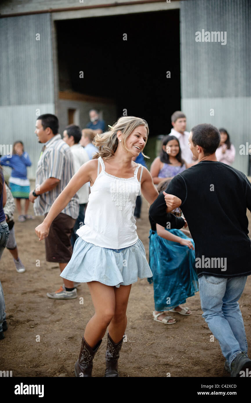 Young woman dancing at barn dance with partner Stock Photo
