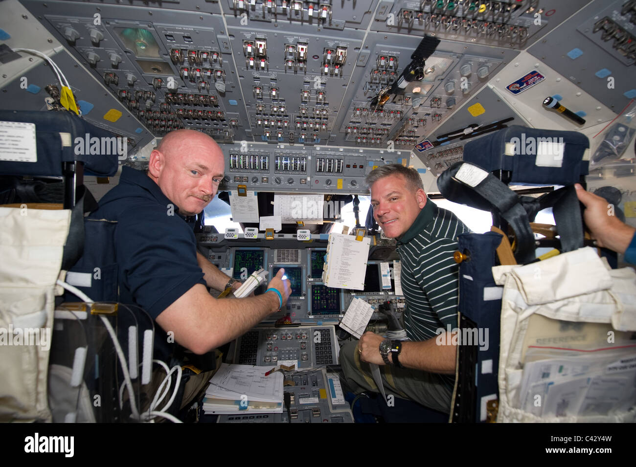 NASA astronauts Mark Kelly (L) and Greg H. Johnson on space shuttle Endeavour docking to the International Space Station Stock Photo