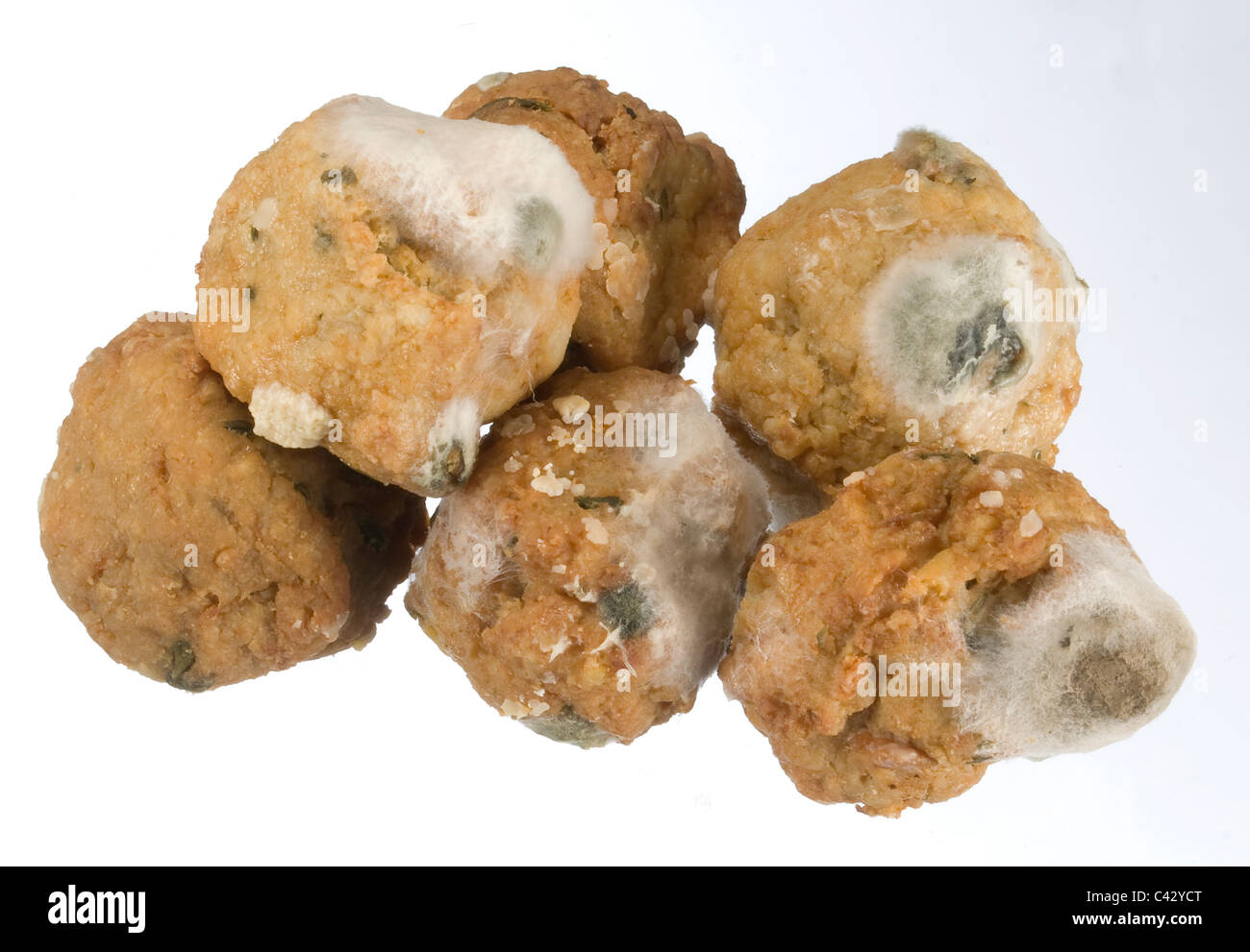 Rotten moldy cooked meat balls which are putrefying Stock Photo