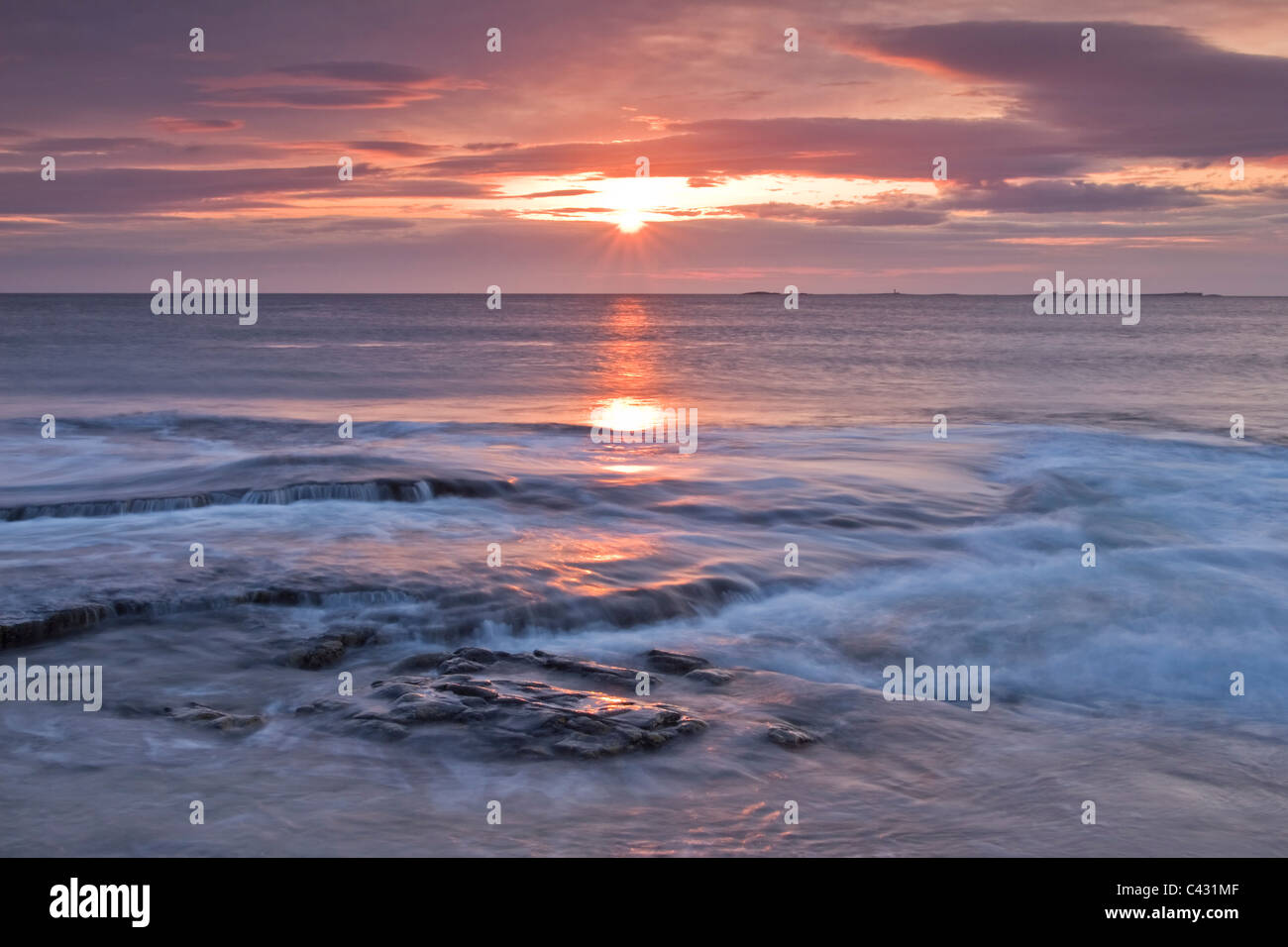 Sunrise over the North Sea looking toward the Farne Islands near Bamburgh, Northumberland, England Stock Photo