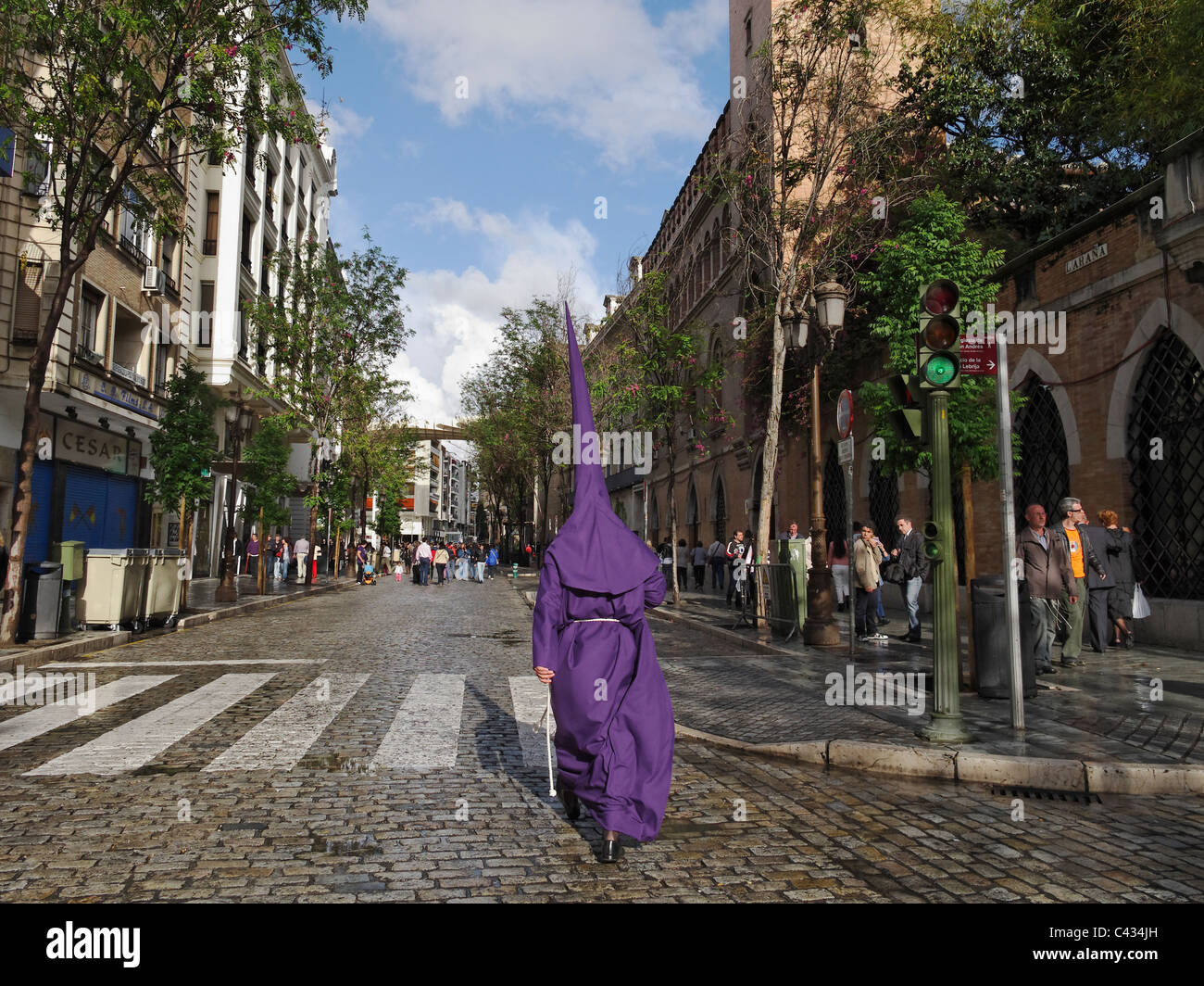 A Nazarene striding through Seville, Spain, during Holy Week (Semana Santa) in Seville, Spain. Stock Photo
