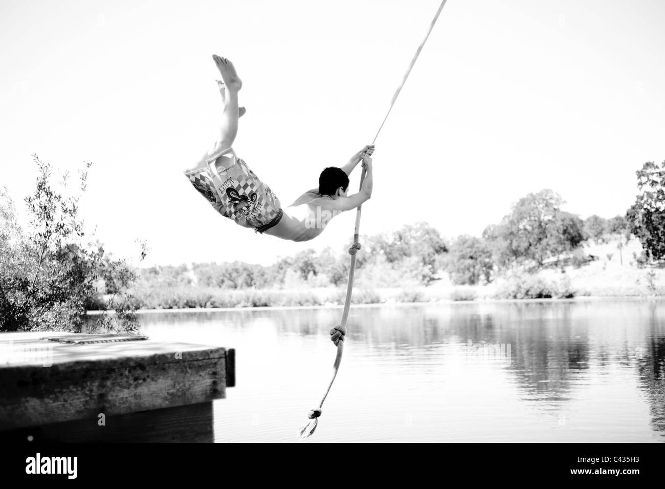 Boy rope swing lake Black and White Stock Photos & Images Alamy