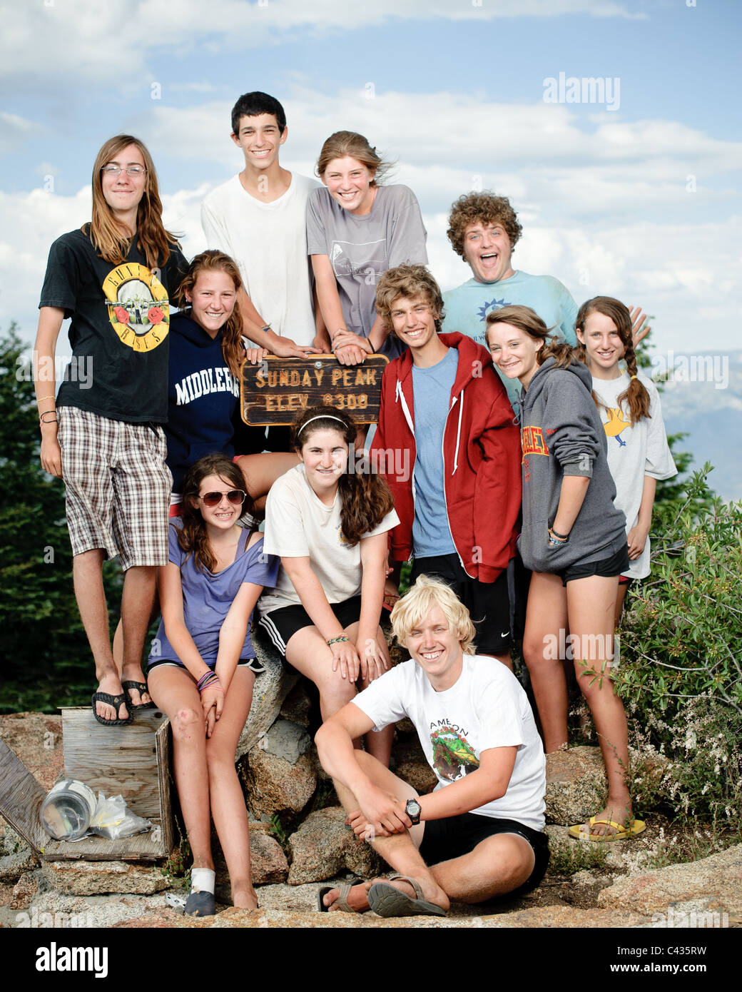 Friends scale a mountain Stock Photo - Alamy