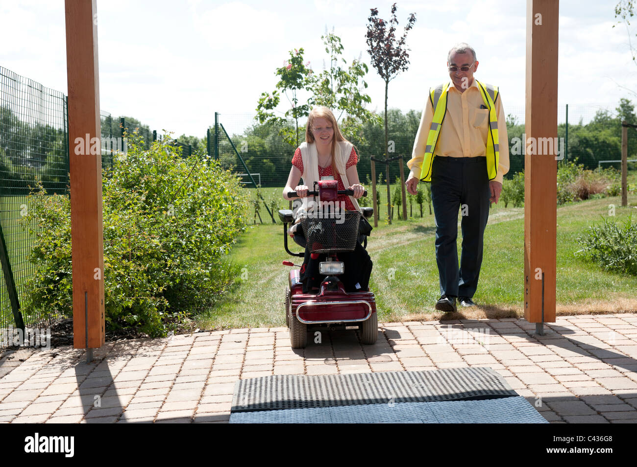 A young disabled girl undergoes instruction in the safe use of a mobility scooter at the Centre for Disability Studies in UK. Stock Photo