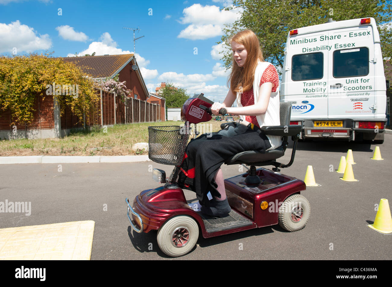 A young disabled girl learning to ride a mobility scooter safely at the  Centre for Disability Studies in Rochford, Essex, UK Stock Photo - Alamy