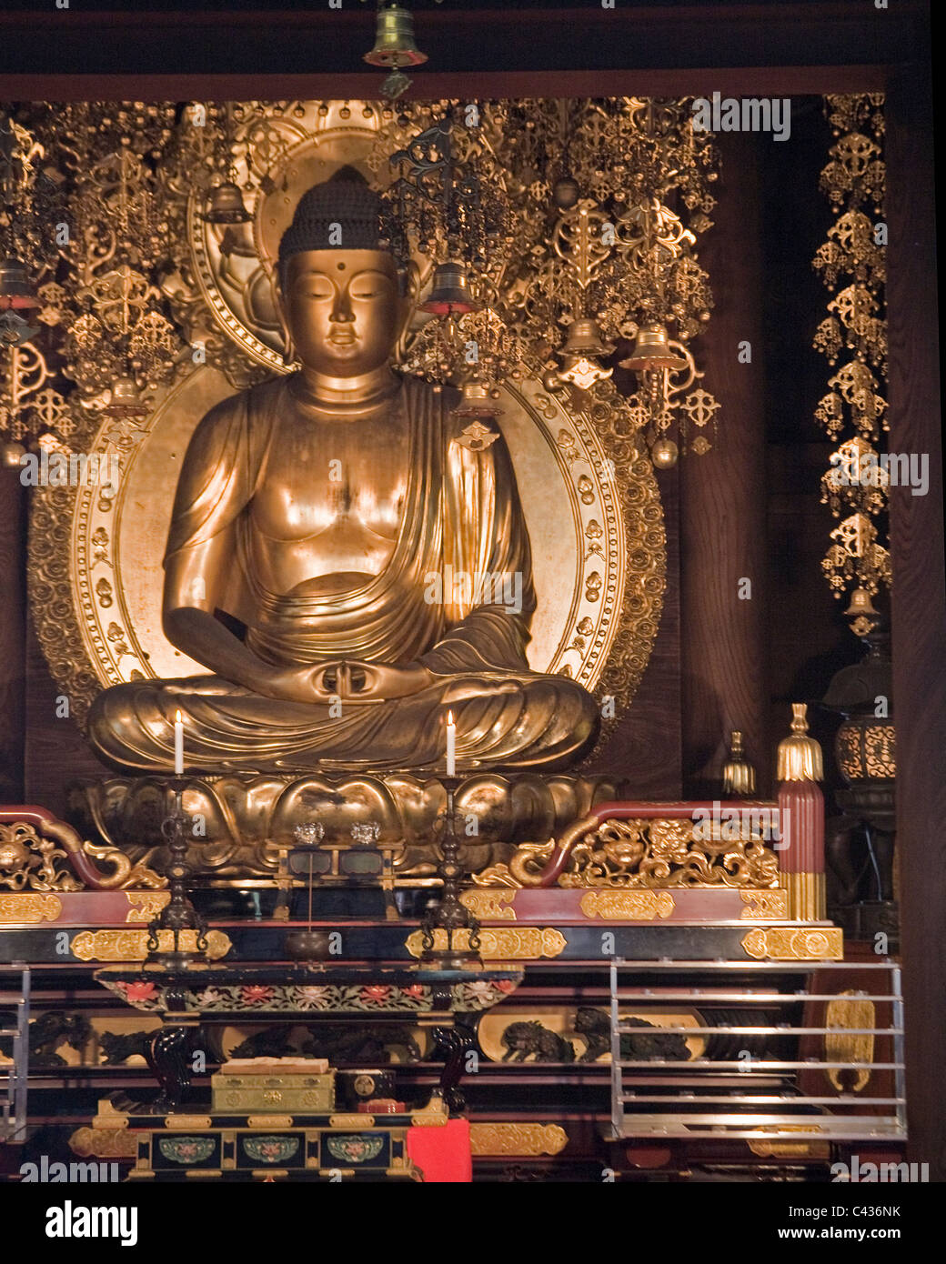 A golden Buddha statue inside a small temple Stock Photo Alamy