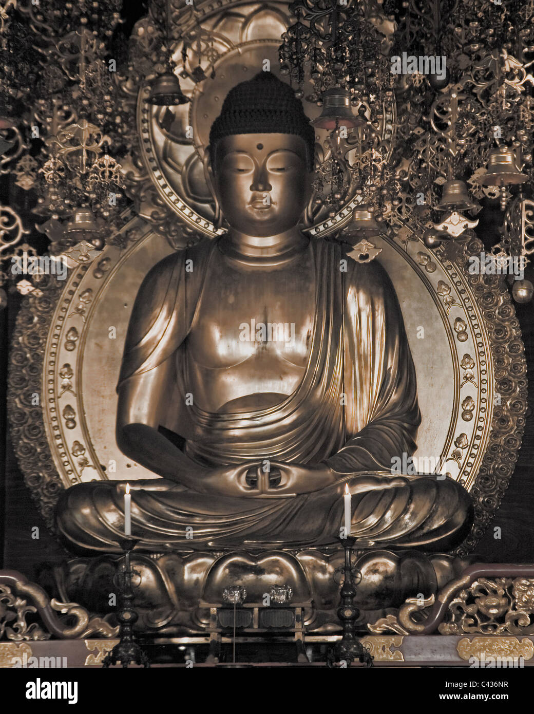 A golden Buddha statue inside a small temple Stock Photo - Alamy