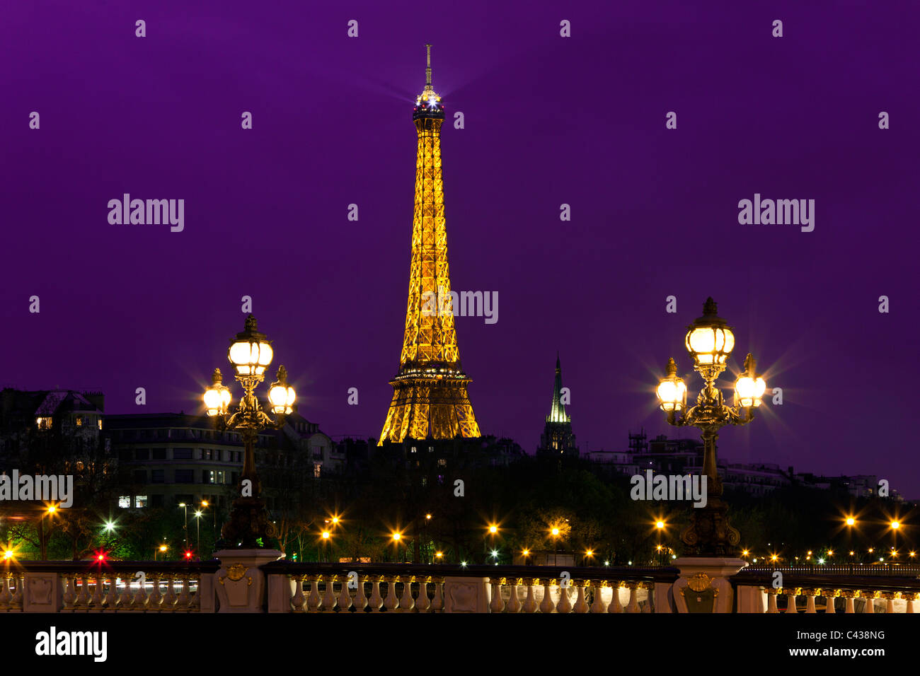 Night illumination on the bridge of Alexander III and Eiffel Tower in the background. Paris. France. Stock Photo