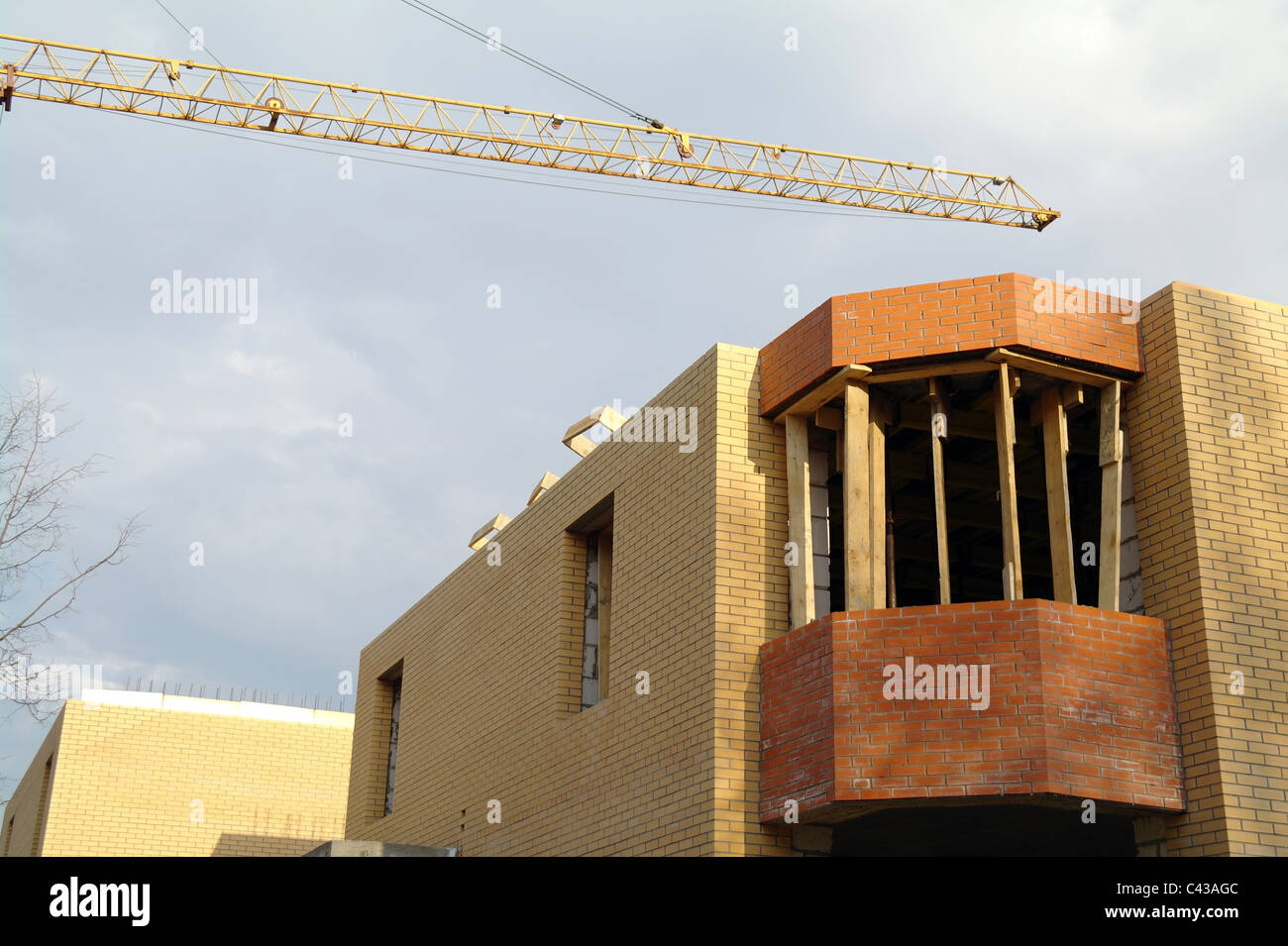 Building of the brick house with the elevating crane, Moscow Region, Russia Stock Photo