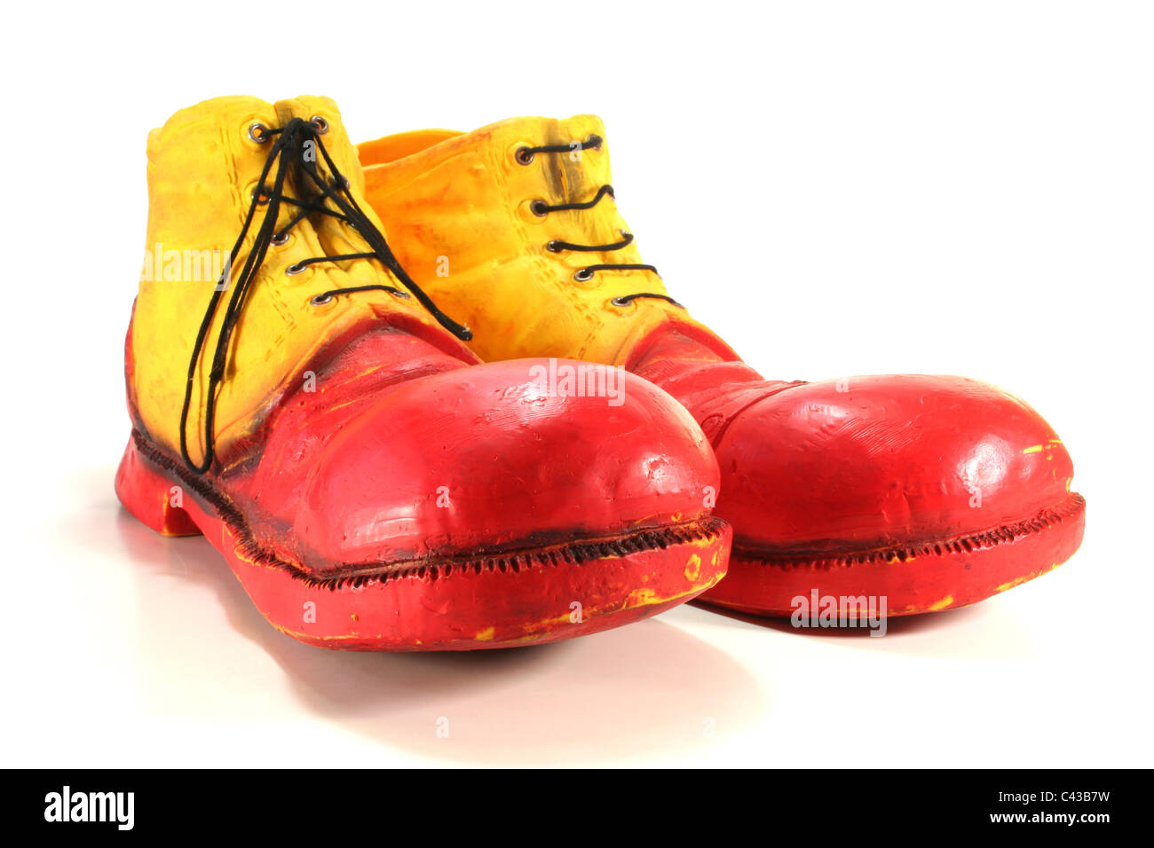 red and yellow clown shoes on a white background Stock Photo