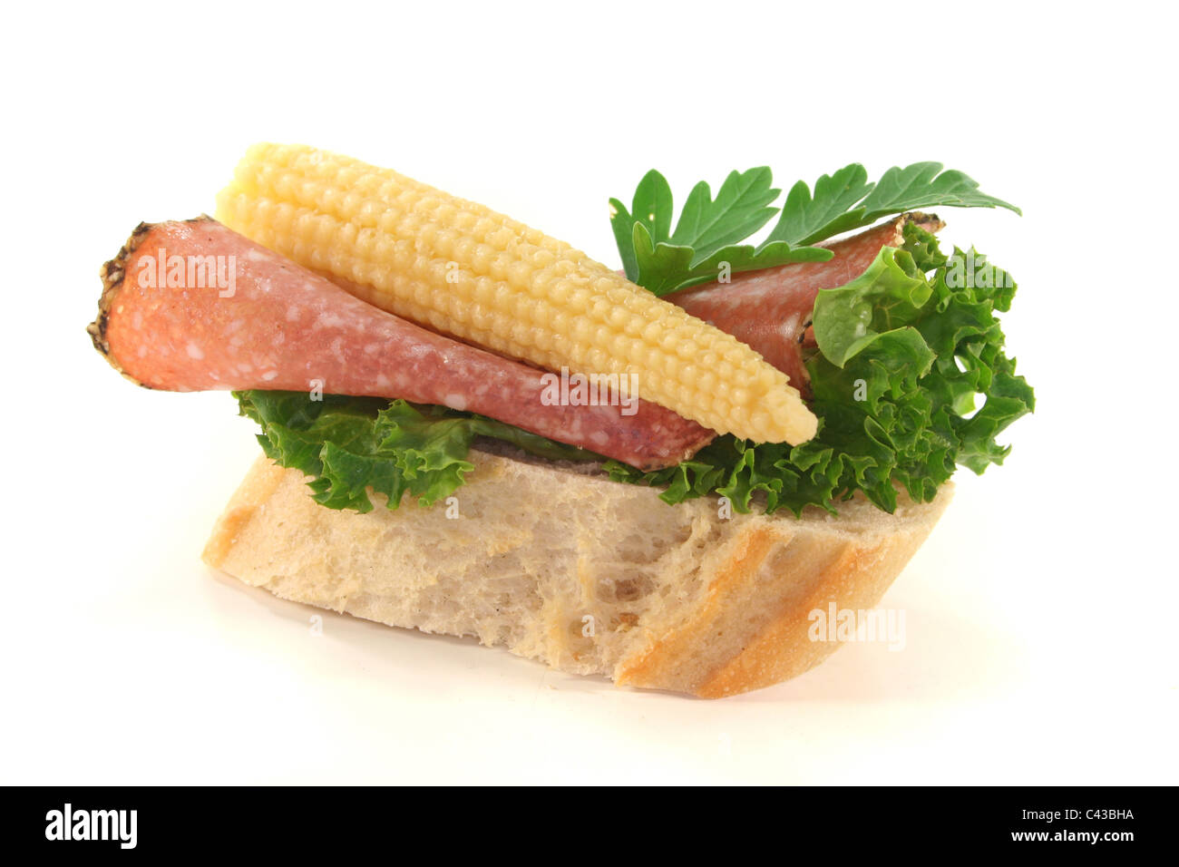 Canape with lettuce, salami, corncob and parsley on a white background Stock Photo