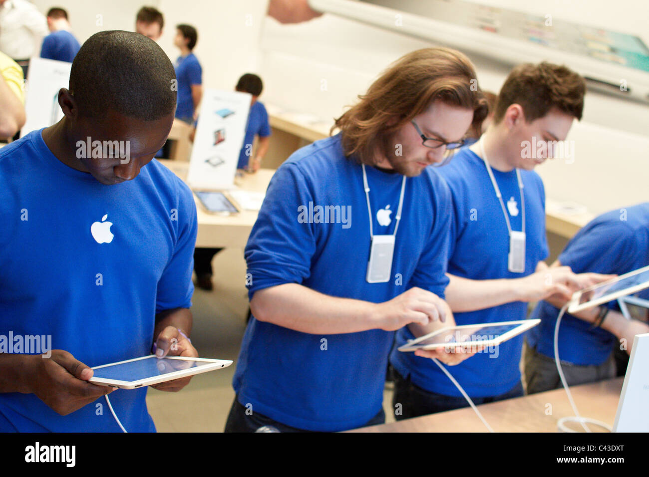 Apple employees learn how to use the iPad2 at the Regent Street Store moments after the product went on sale. Stock Photo