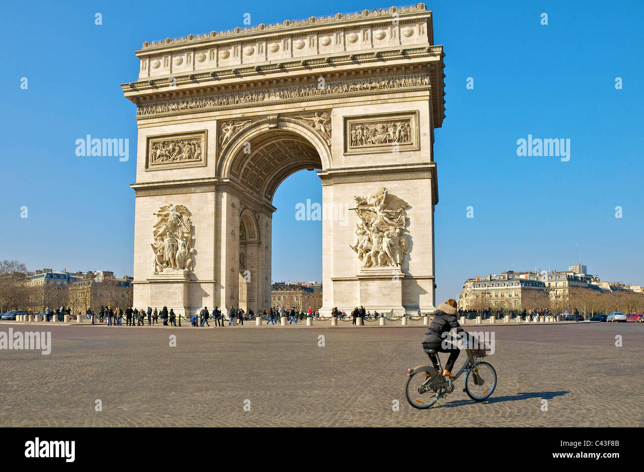 Etoile and Arc de Triomphe Paris with a lone cyclist. Stock Photo