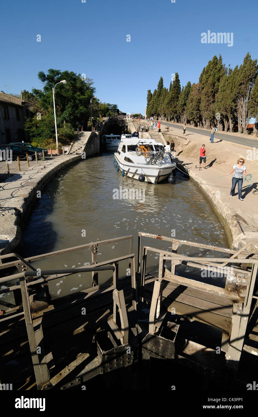 Canal Boat or Longboat in Lock (Neuf Ecluses) on the Canal du Midi Beziers Hérault France Stock Photo