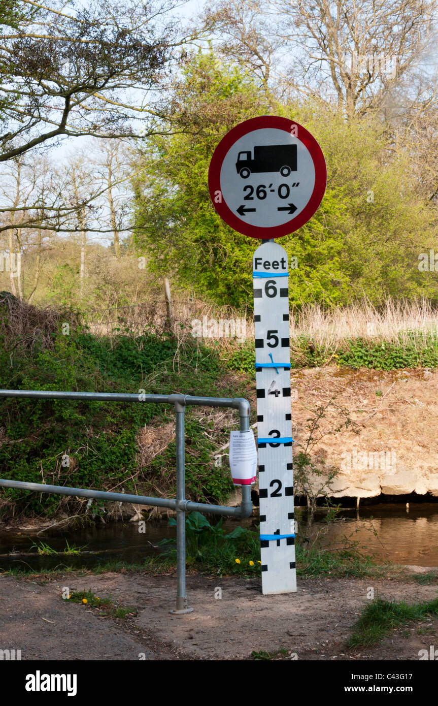 An uncovered depth guage on a river in southern England with sign showing vehicle length restriction Stock Photo