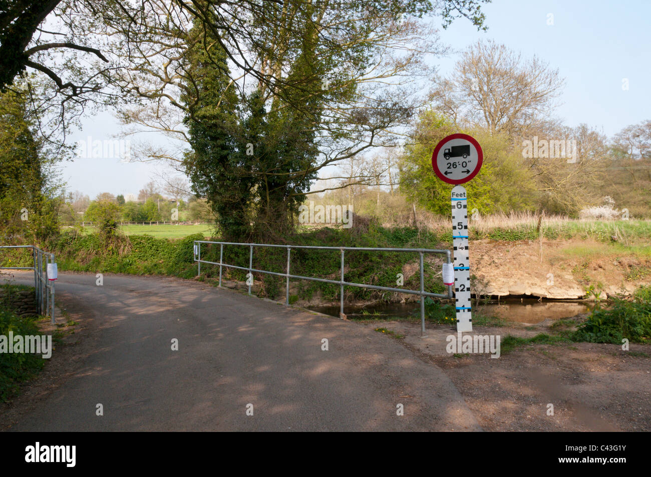An uncovered depth guage on a river in southern England with sign showing vehicle length restriction Stock Photo