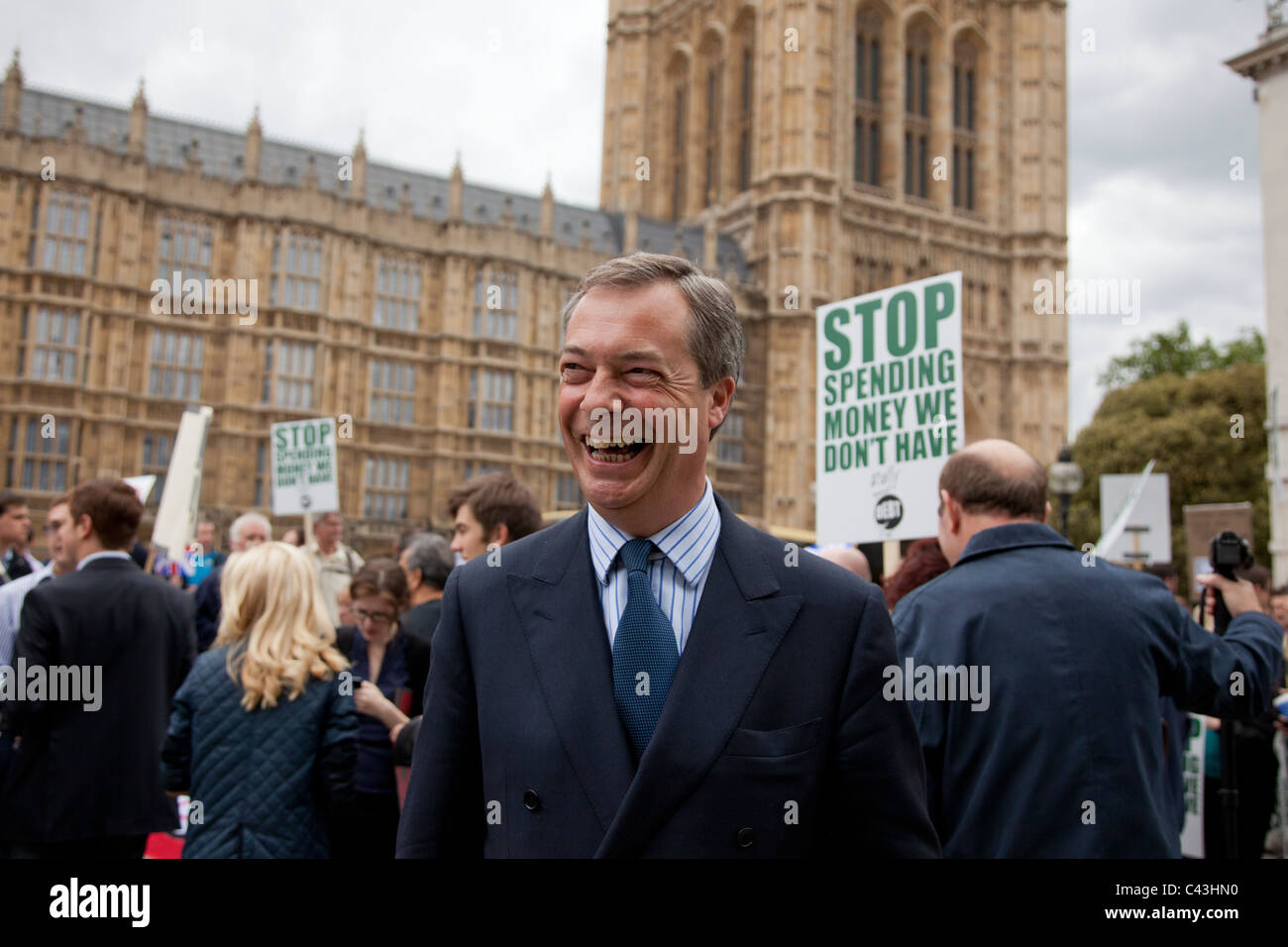 UKIP leader Nigel Farage smiles outside Parliament during a pro-cuts protest in support of government fiscal cutbacks. Stock Photo