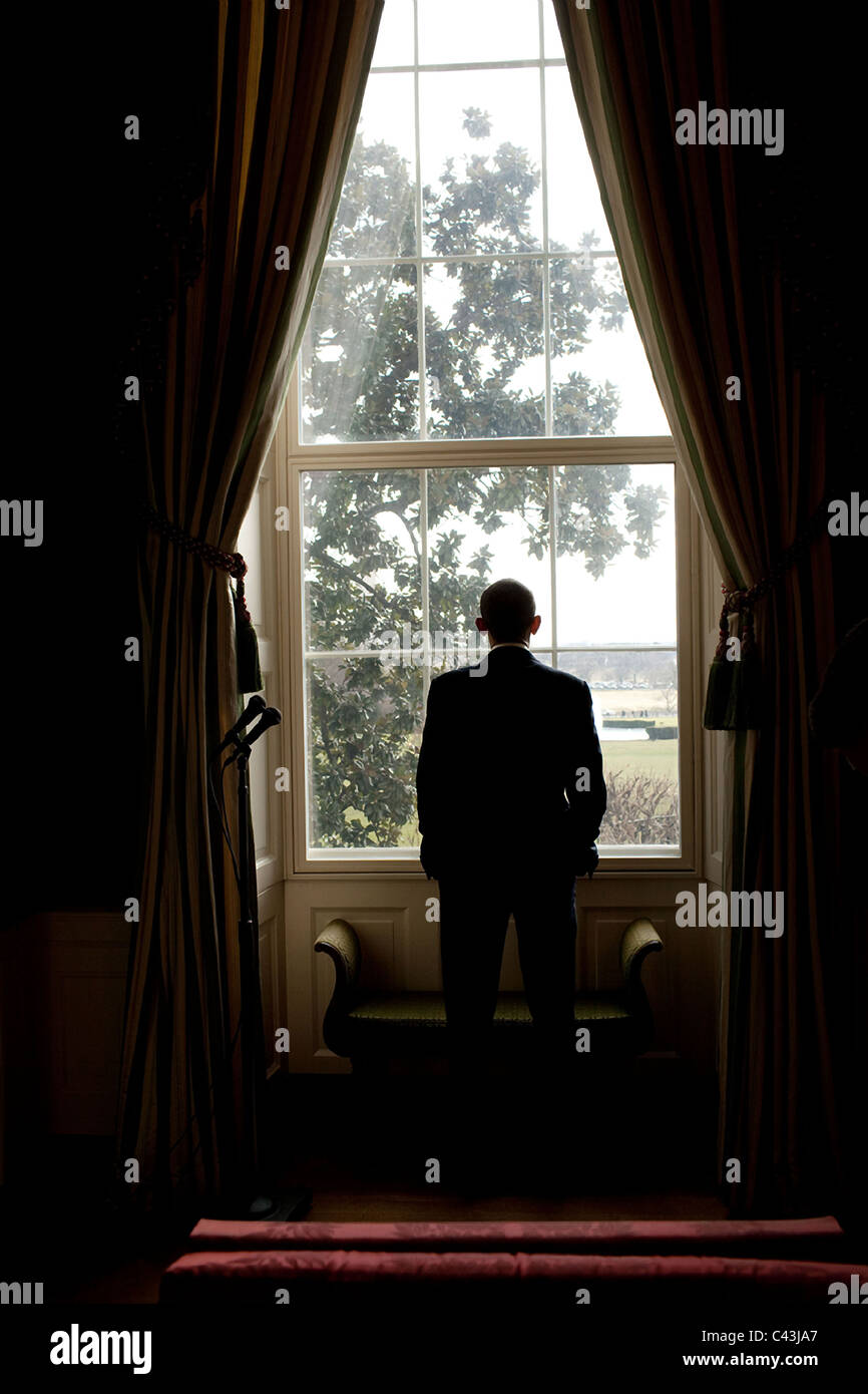 US President Barack Obama looks out the window of the White House Stock Photo