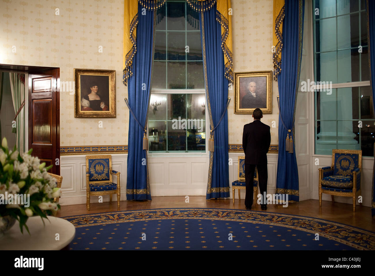 President Barack Obama looks at a portrait of President John Adams while waiting in the Blue Room prior to his press conference Stock Photo