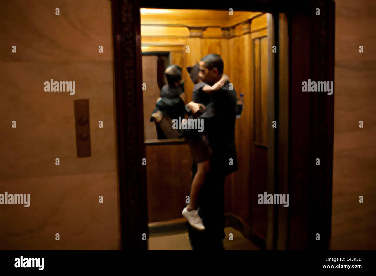 President Obama carries daughter Sasha in the elevator ready to head upstairs to the private residence at the White House Stock Photo