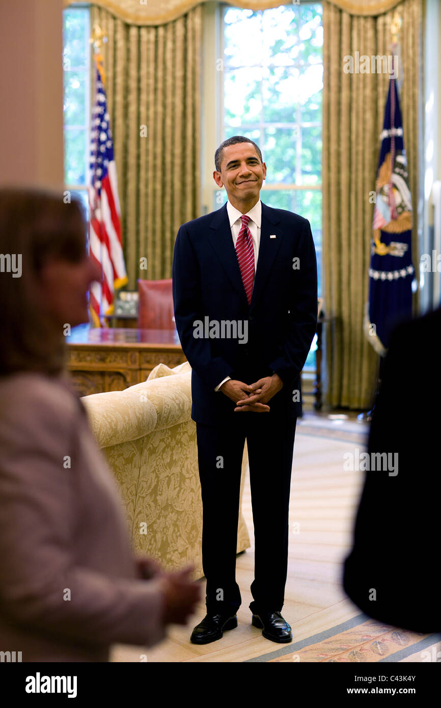 President Barack Obama waits to greet arriving foreign ambassadors in the Oval Office, May 20, 2009. Stock Photo