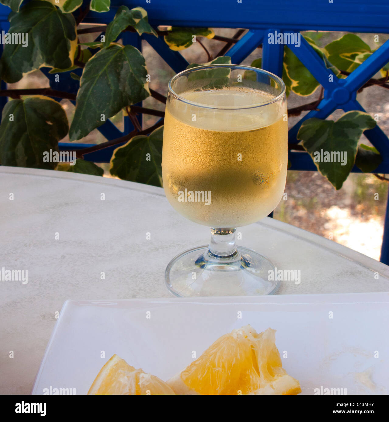 GLASS OF GREEK WHITE WINE ON A TAVERNA TABLE Stock Photo