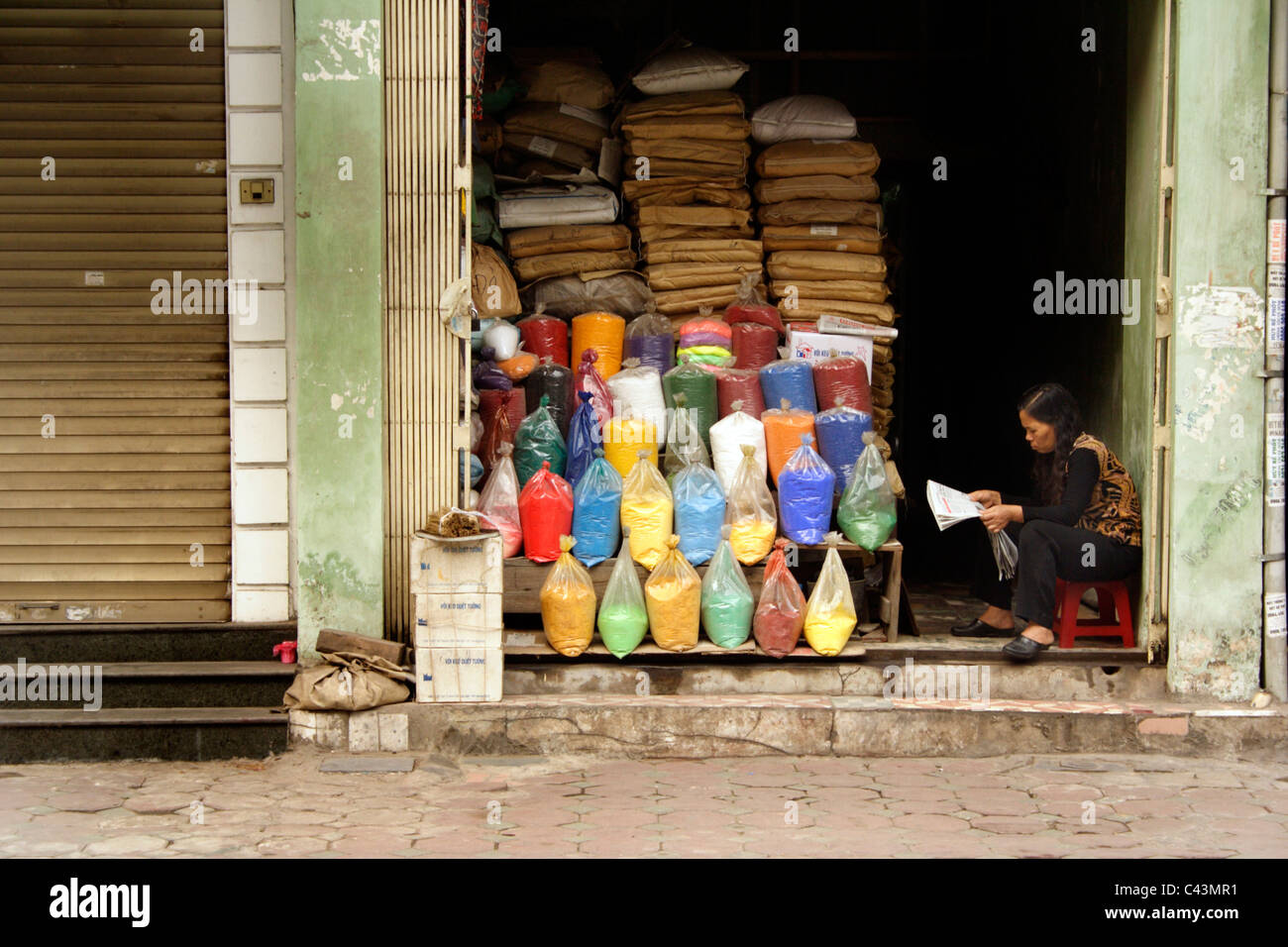 Colourful Colorful Bags Of Paint Powder Or Pigments On Sale At Paint Street In Hanoi Vietnam Woman Seller Reads Newspaper Stock Photo Alamy