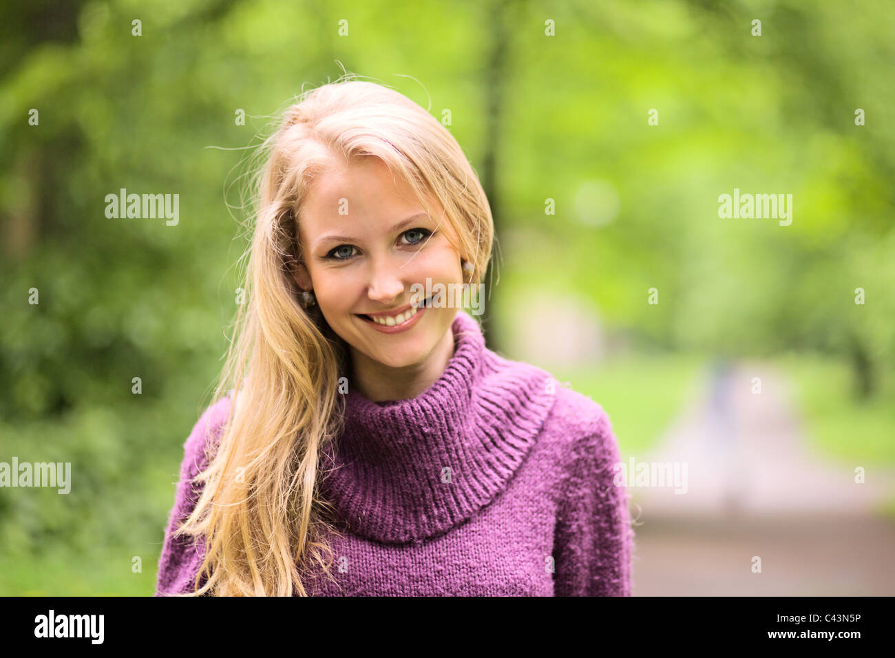 The young smiling woman in park Stock Photo - Alamy