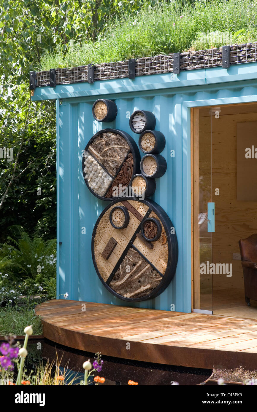 Garden office made from a shipping container. Features a living roof and insect habitat