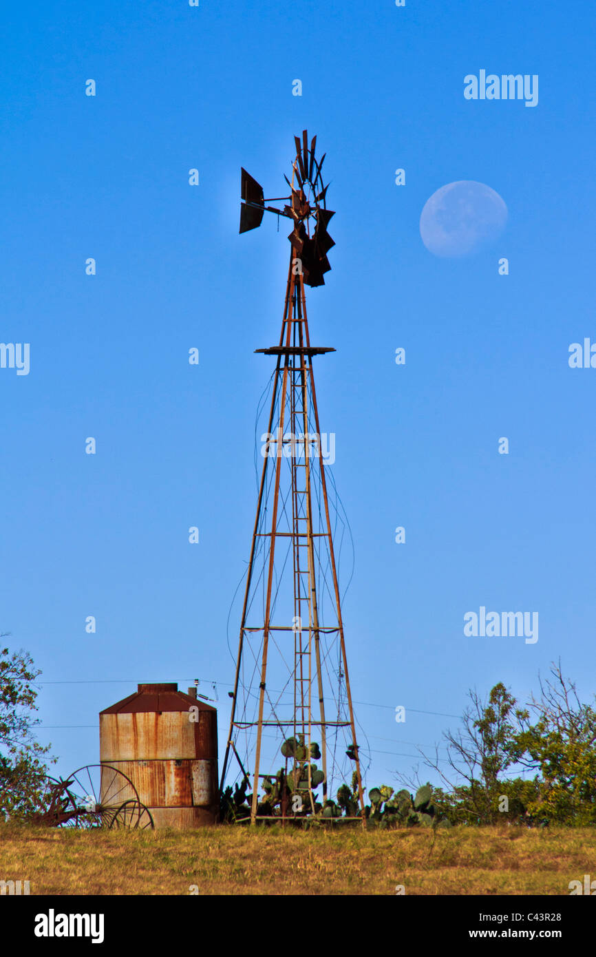 big moon by day, Lake Texoma, morning time, Texas, TX, water cistern, wind mill, windmill Stock Photo